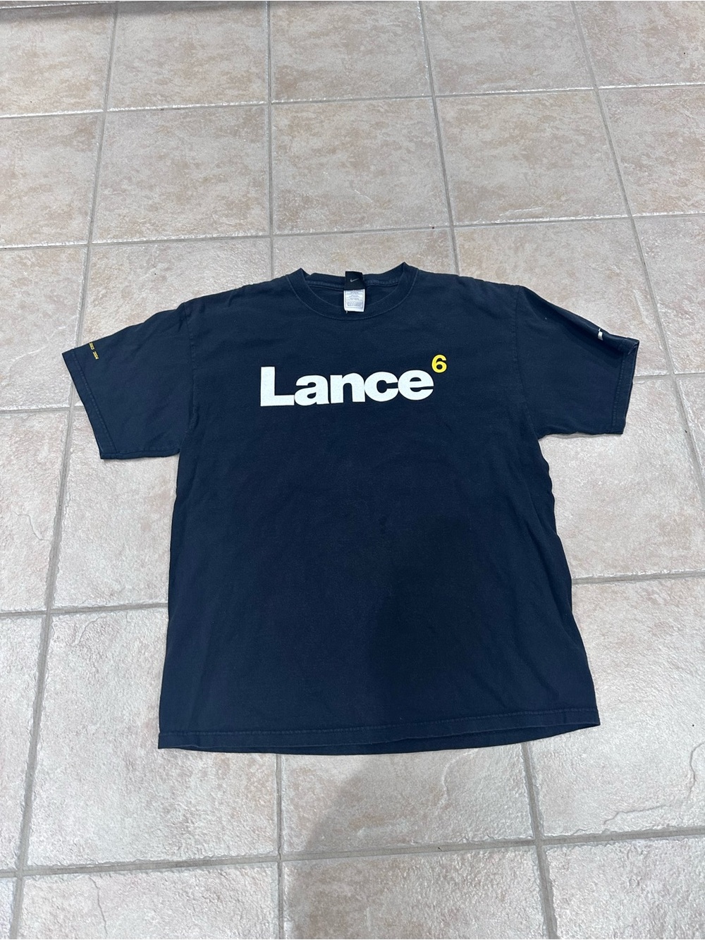 Nike Black Graphic Tee with White Lance Logo and Yellow Accent
